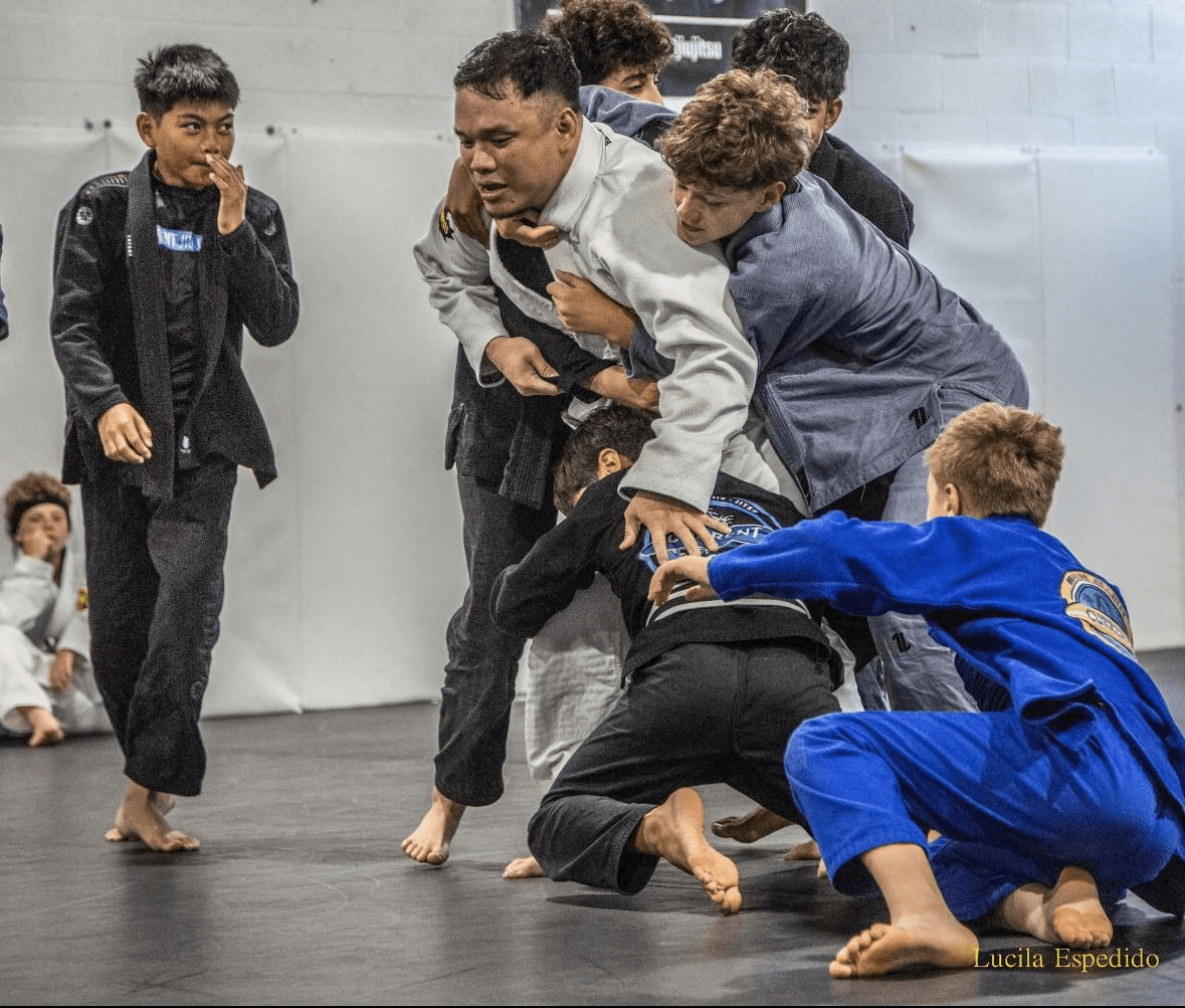Teen jiu-jitsu students practising control during live training