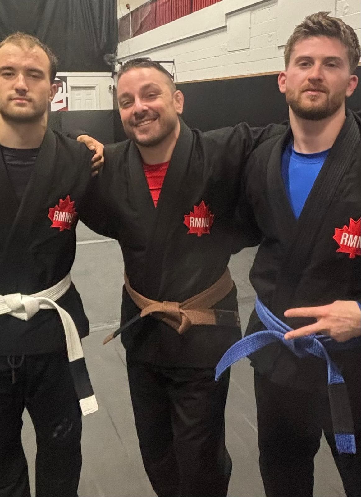 United Grappling Club members representing white, brown, and blue belt progression